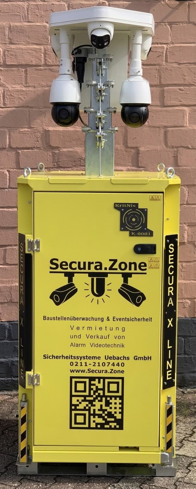 Der erste KritNis-Turm: gelbe Box der Reihe Secura X-Line mit Mast und Systemkopf, Typenschild K-0001 an der Tür.